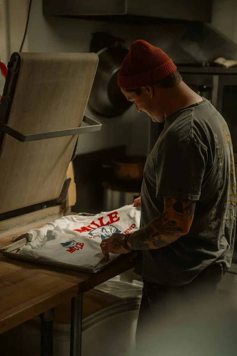Screen printing a T-shirt in a creative workshop